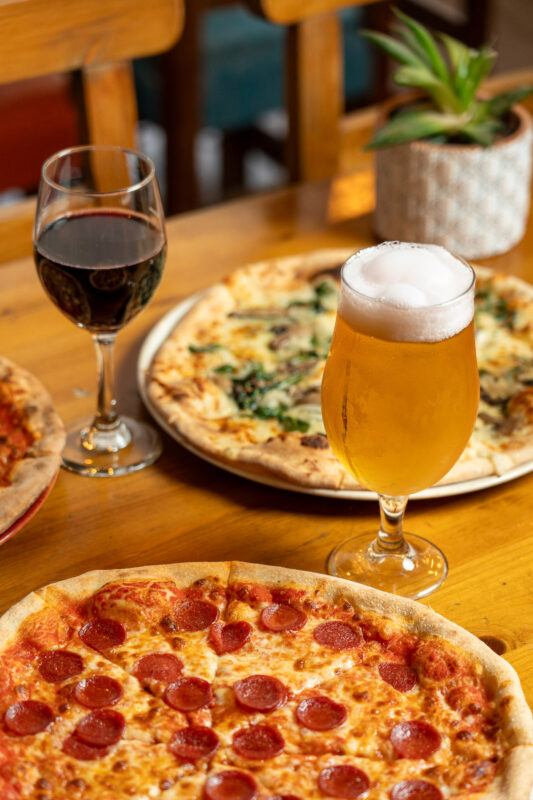 A cold beer pairs perfectly with a hearty wood-fired pizza or a juicy smash burger. Check it out at Gracy's.