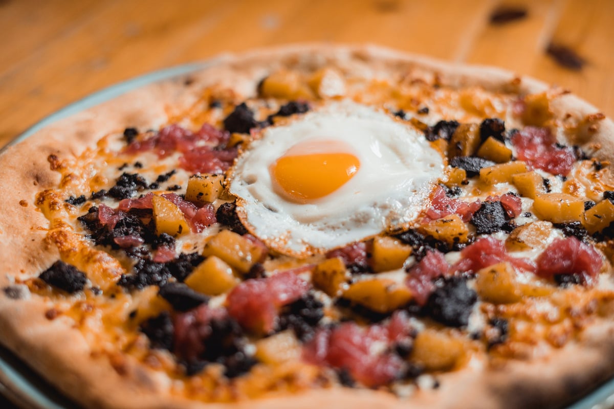 The Farmyard woodfire pizza at Gracy's topped with Kelly’s Black Pudding and an Egg.